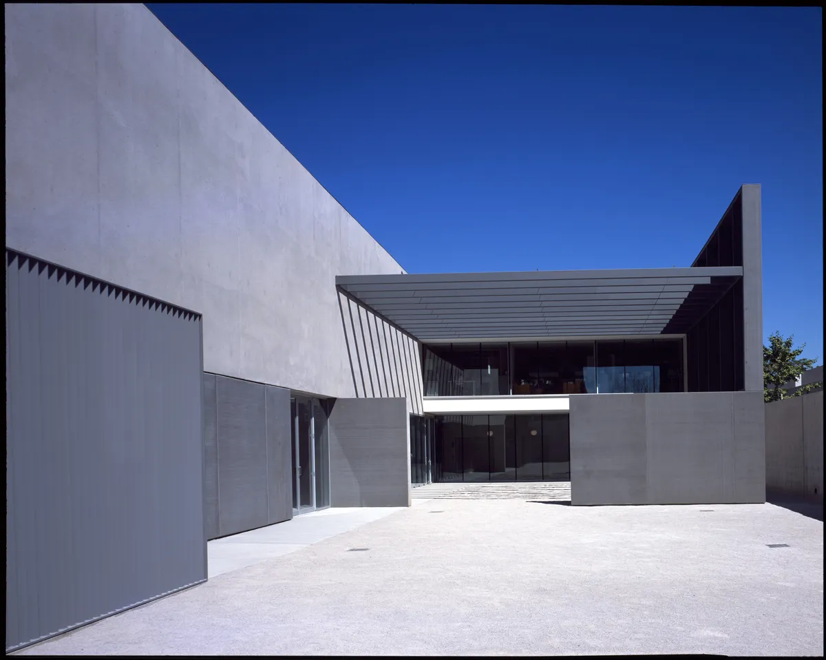 Exterior of a modern concrete commercial building under blue sky