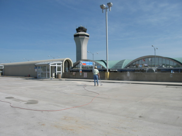 Worker levels the top of Lambert Airport's Main Terminal Garage