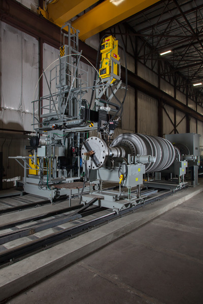 Large industrial turbine or generator equipment inside a high-bay warehouse facility