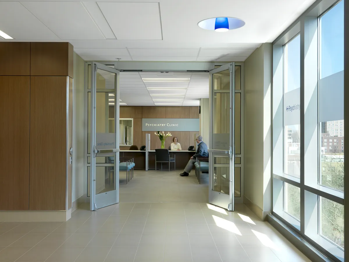 Wide healthcare corridor with natural light and clean modern finishes
