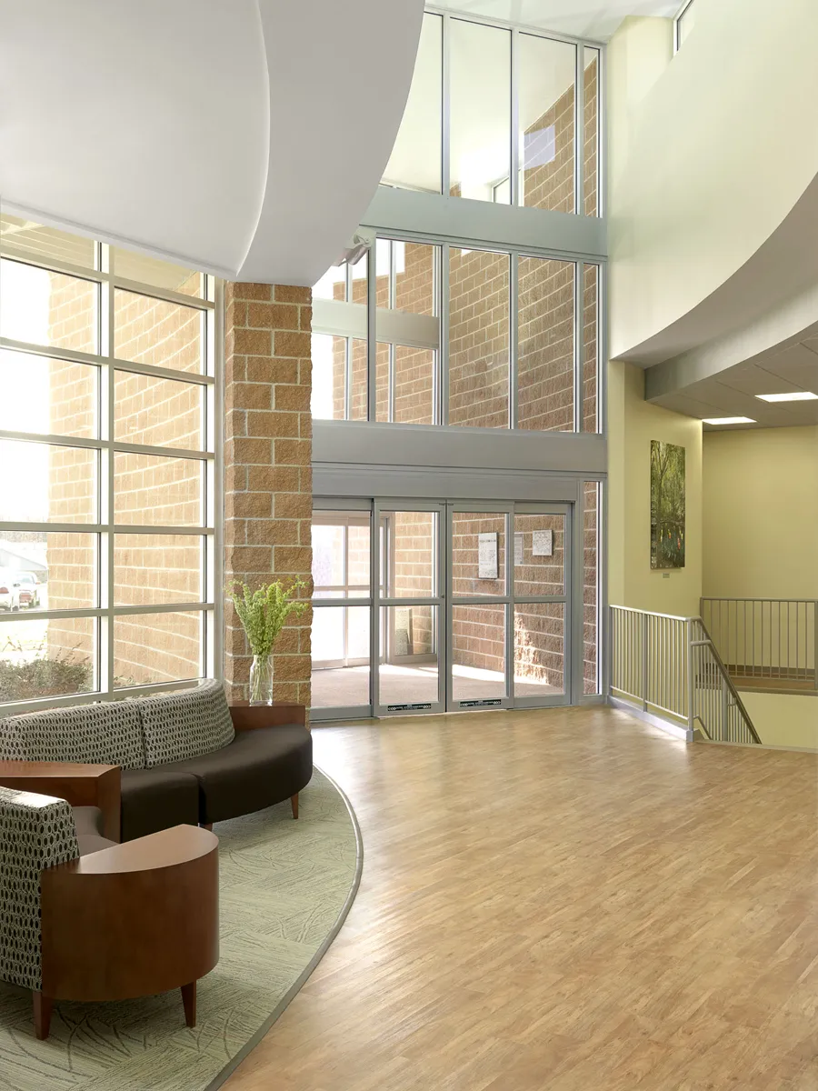 Modern waiting room or lounge with wood floors and natural light