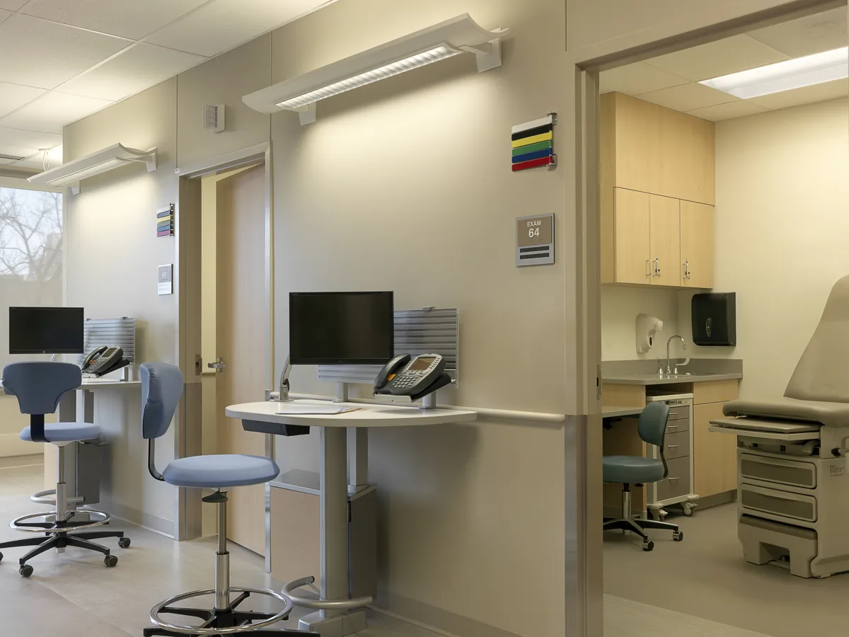 Clinical workstation area with computers and overhead cabinetry