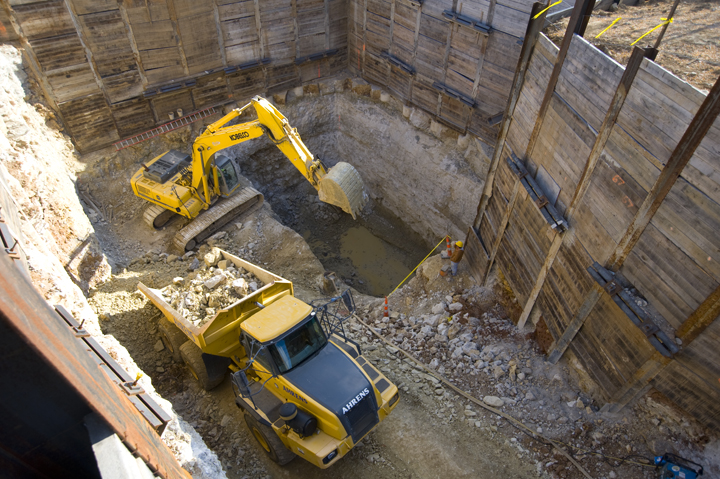 construction equipment digging large hold on site