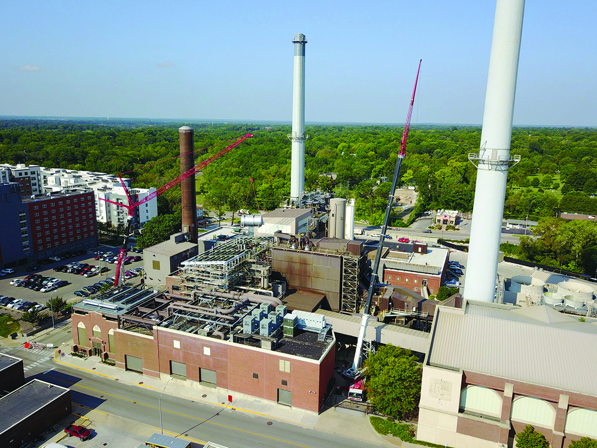 crane lifting large equipment into power plant