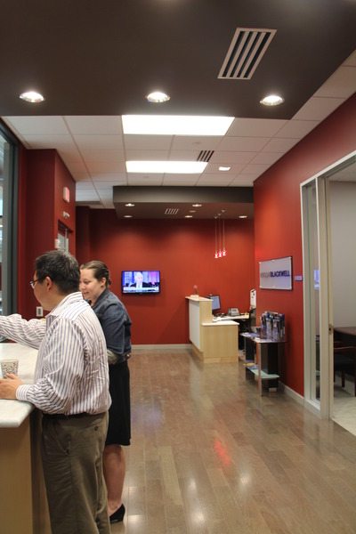 man and woman standing a reception desk