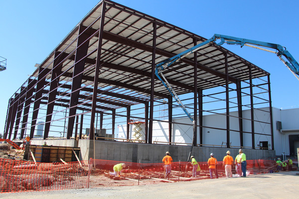 Steel structural framework being erected at an outdoor construction site