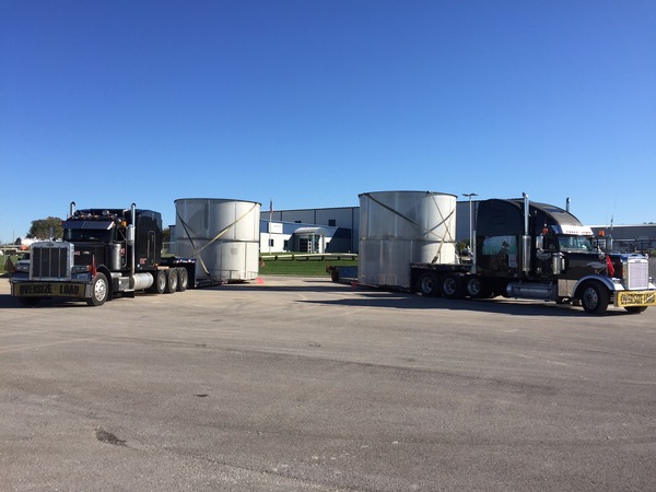 Exterior of a commercial building with delivery trucks in a parking lot