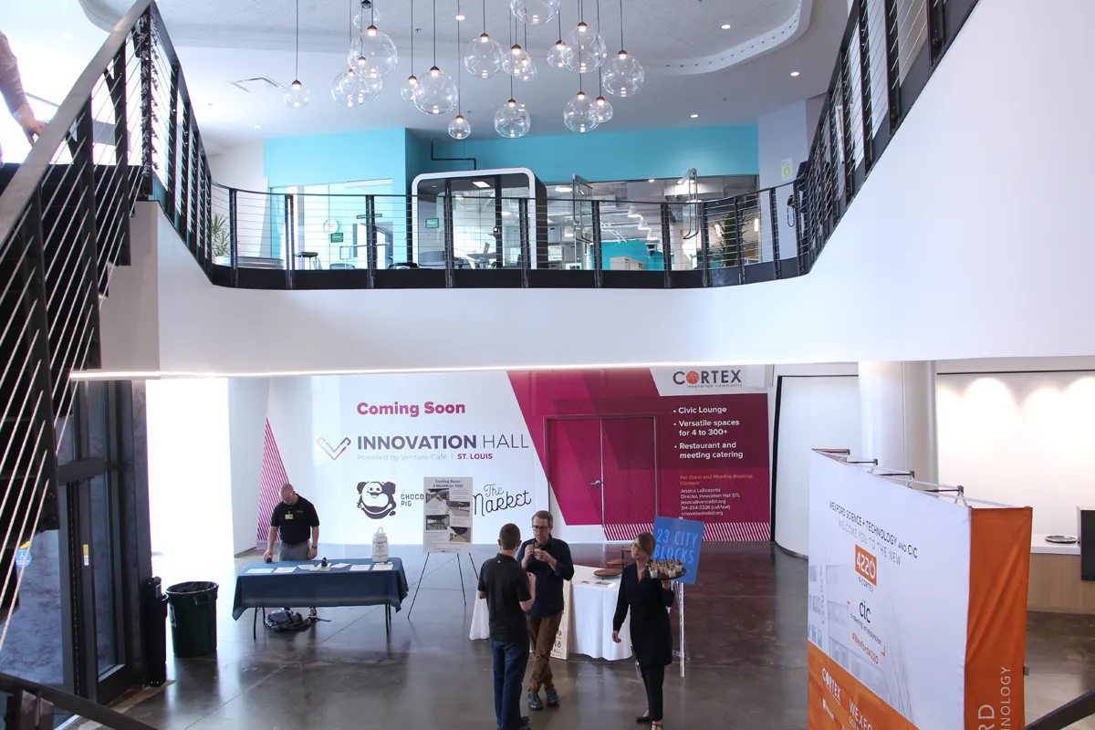 Two-story open office or innovation center with colorful signage and mezzanin