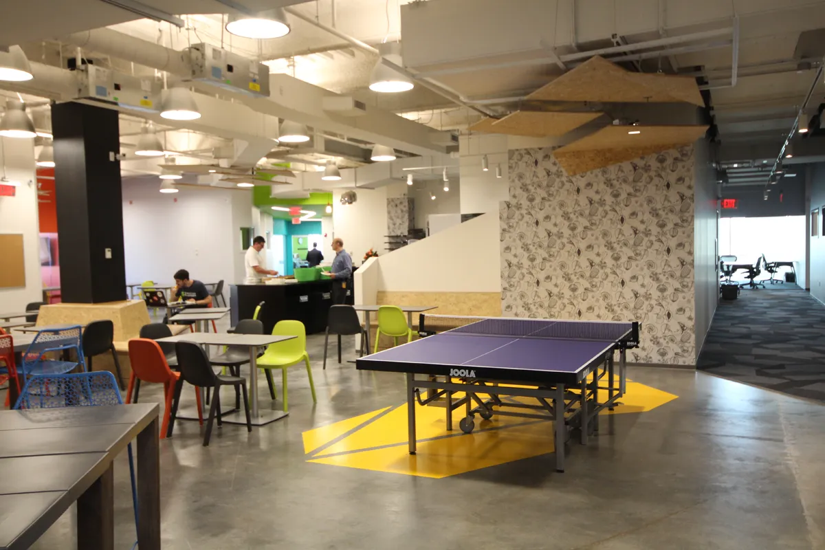 Modern office lounge with ping pong table and open collaborative layout