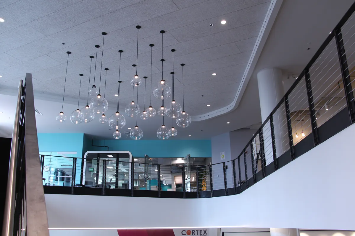 Two-story open office with mezzanine and chandelier