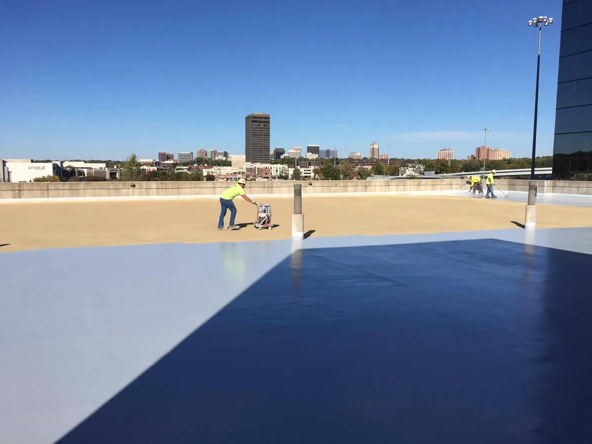 Aerial view of a flat rooftop with blue skylight or roofing membrane detail