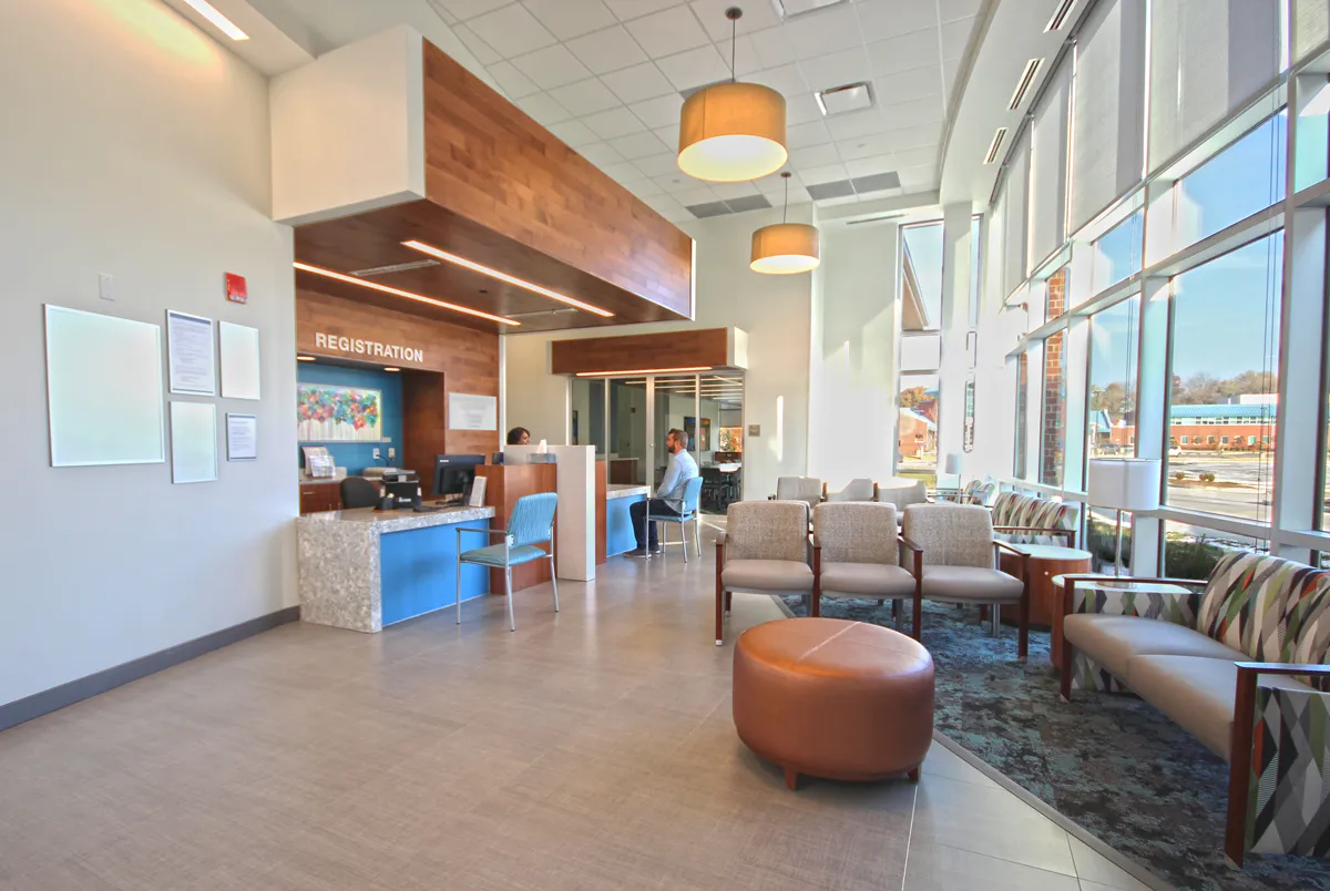 Healthcare corridor with wood accents, artwork, and natural light