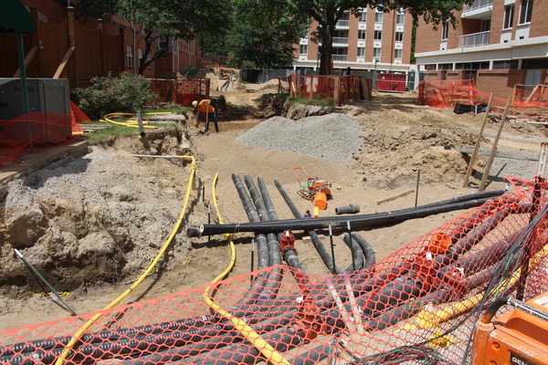 Underground utility or infrastructure work with colorful pipes being installed