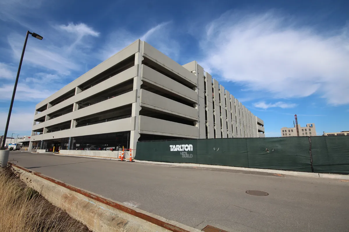 Multi-story parking structure exterior with open bays and blue sky