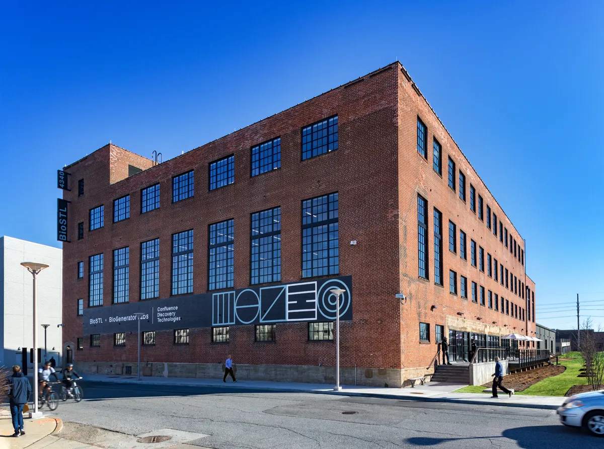 Exterior of a multi-story red brick commercial or mixed-use building