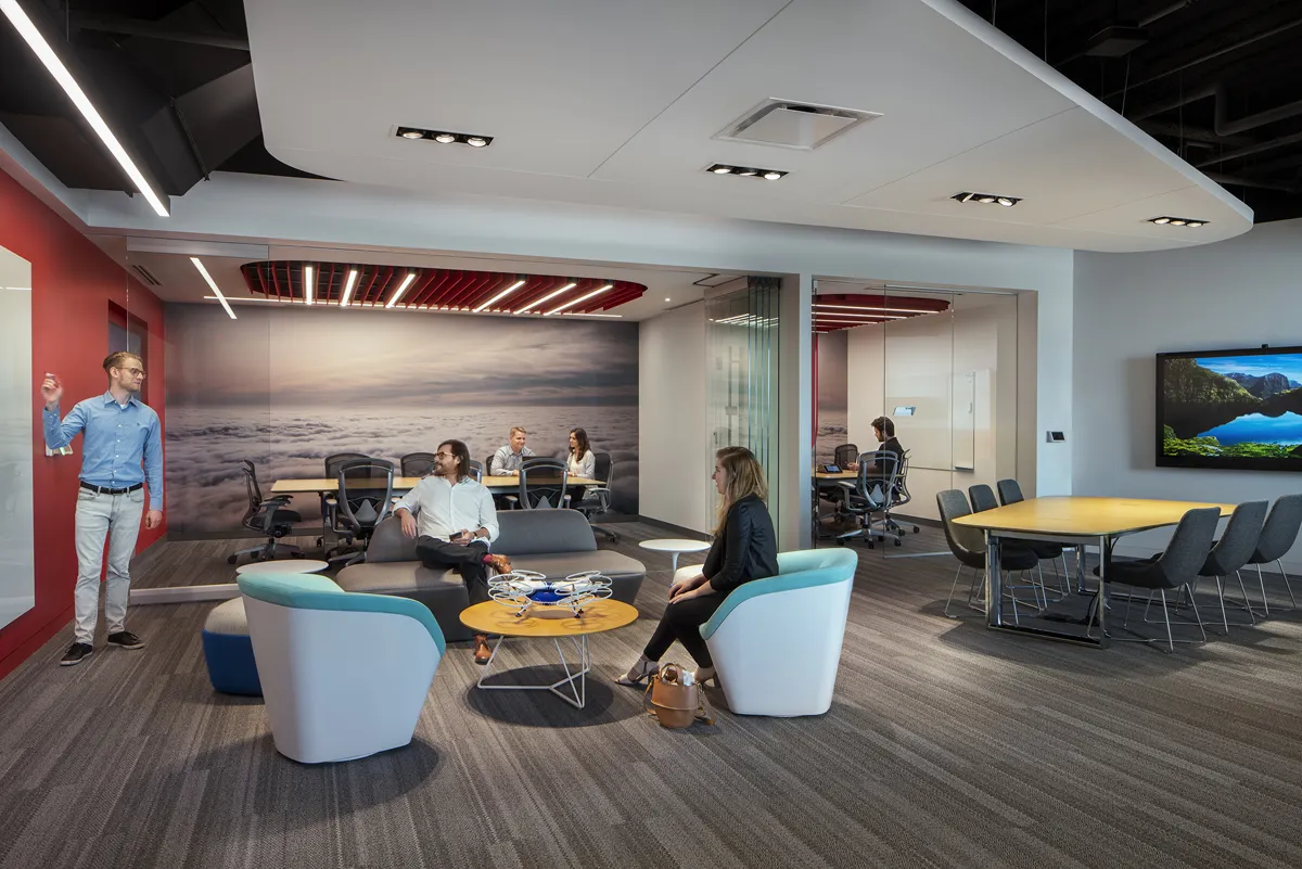 Open collaborative office or lounge area with modern furniture and neutral tones