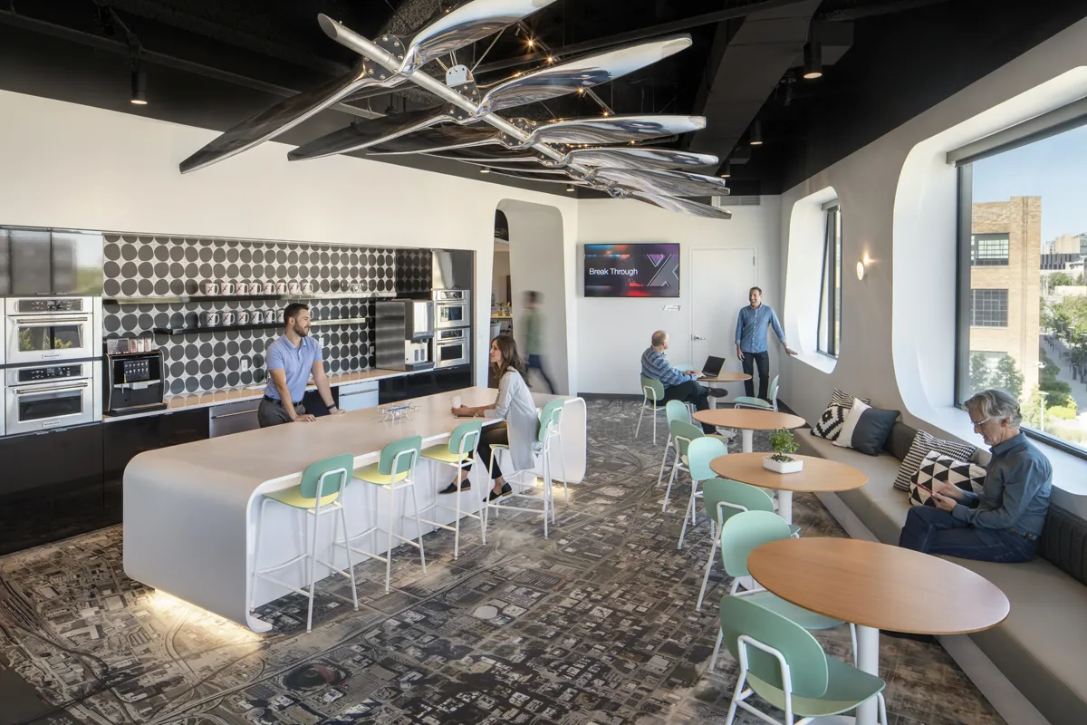 Open collaborative office or lounge area with modern furniture and neutral tones