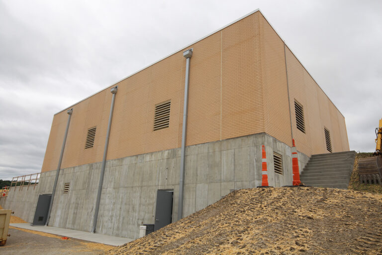 Exterior of a completed brick building with neutral facade