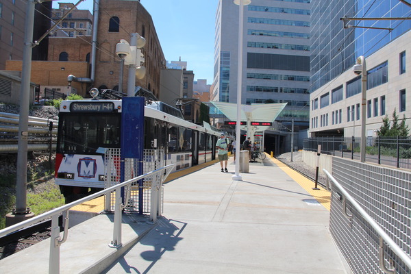 Street-level view of an urban construction site with multi-story buildings