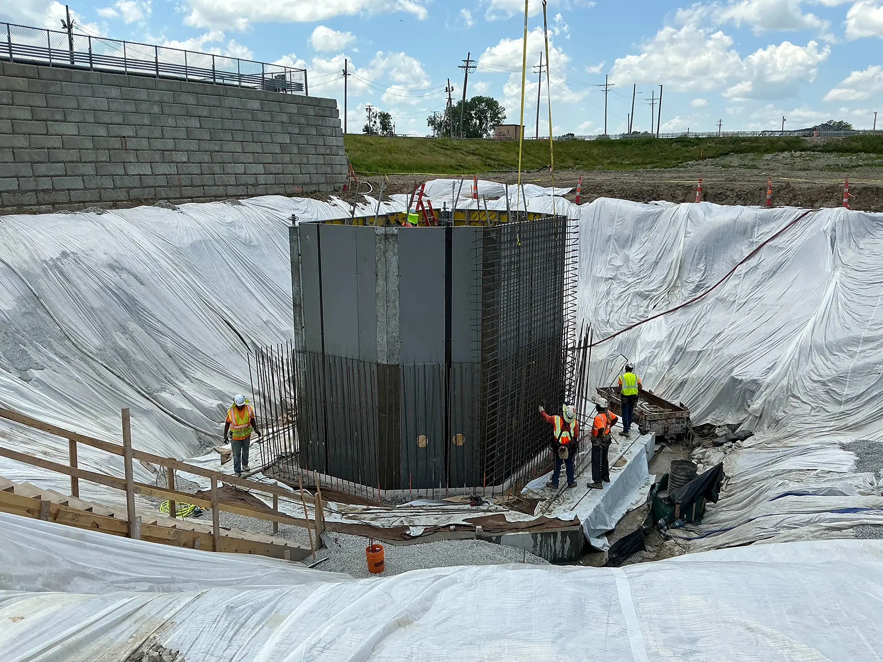 Construction workers replacing water plant basin