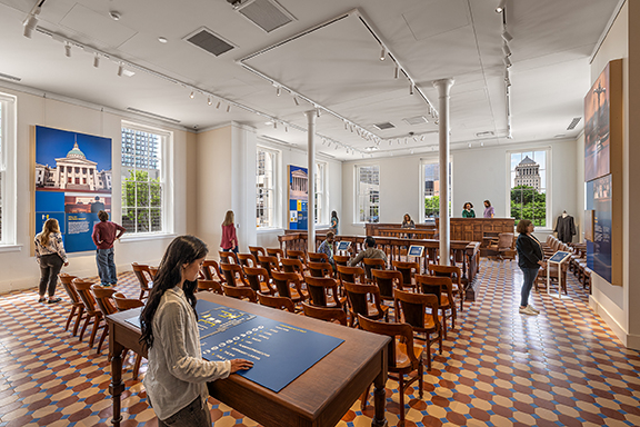 Open museum space with exhibits and visitors on a main floor