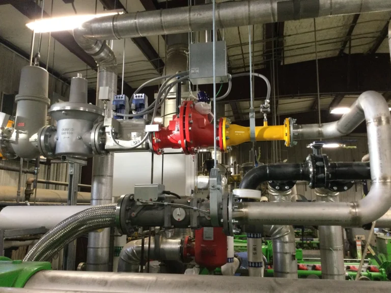 Industrial mechanical room with large red and green generator equipment