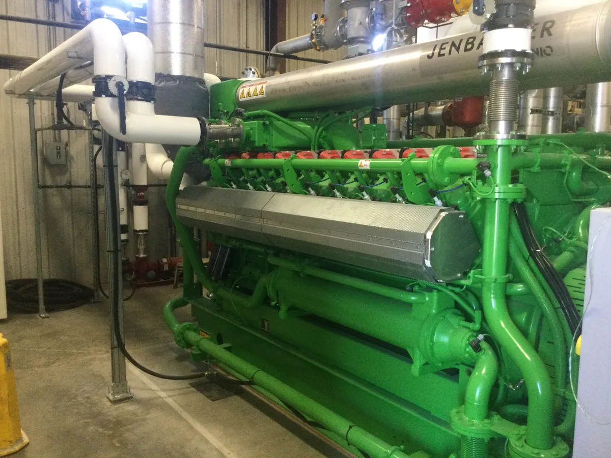 Large green industrial generators or mechanical equipment in an energy facility