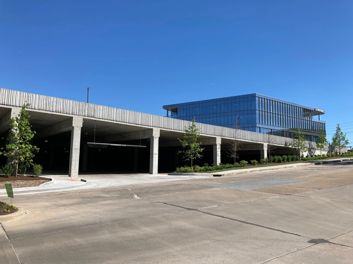 Exterior of a modern glass and steel commercial building under blue sky