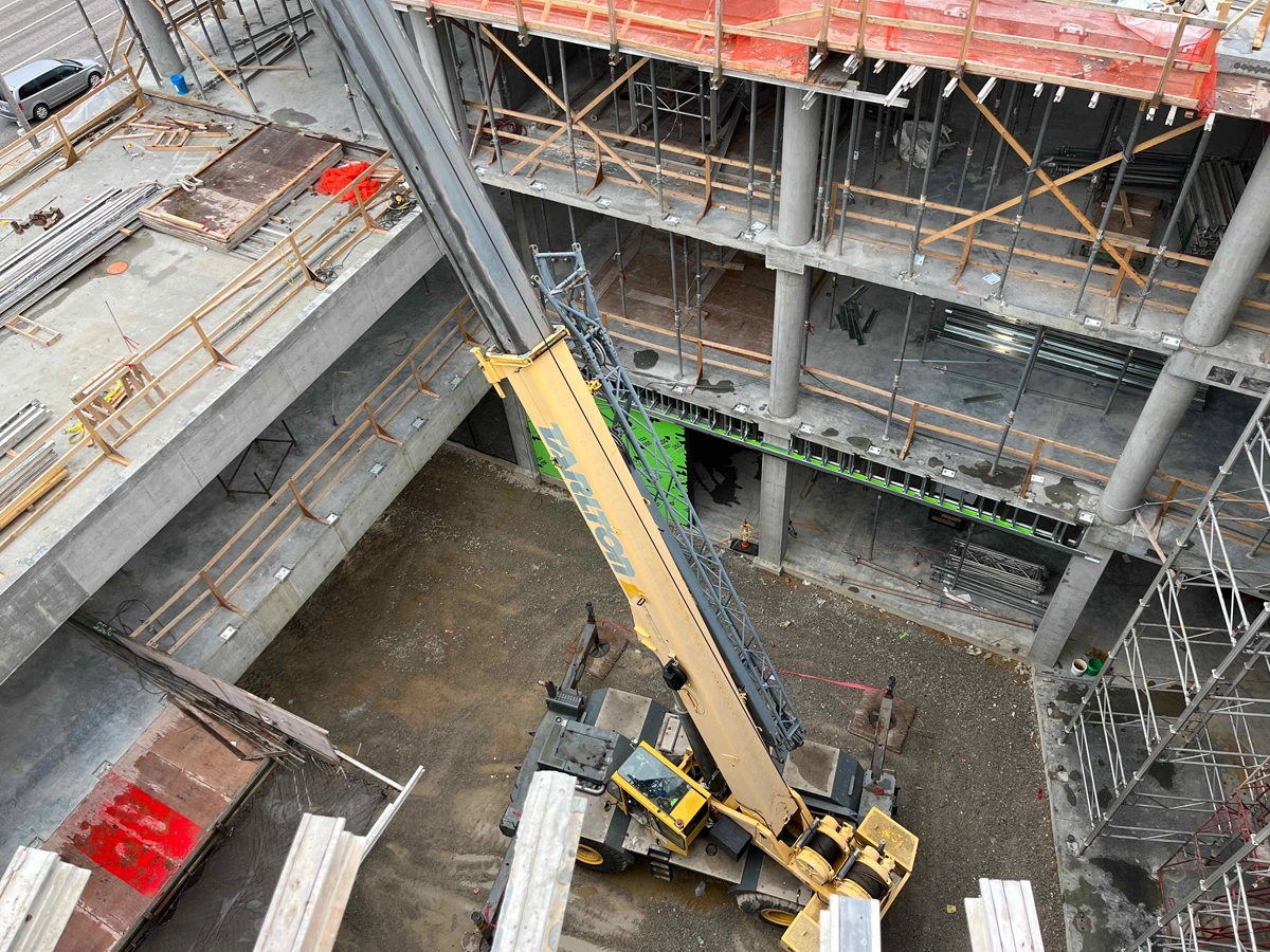 Close-up of red and steel structural framing at a construction site