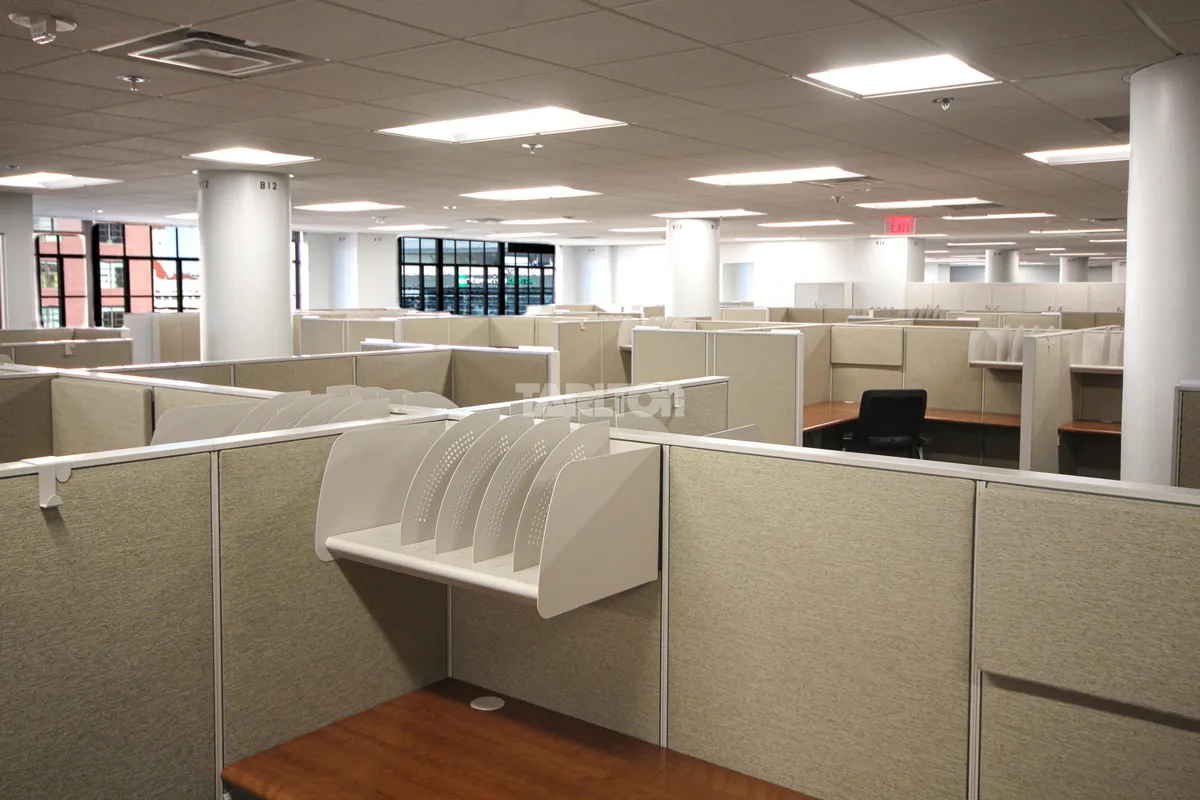 Empty office space with modular workstations and drop ceiling