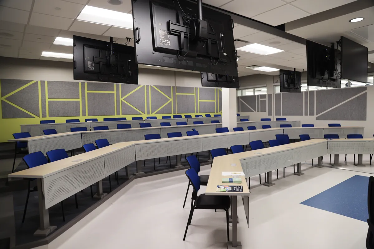 Large classroom space with stadium seating and desks