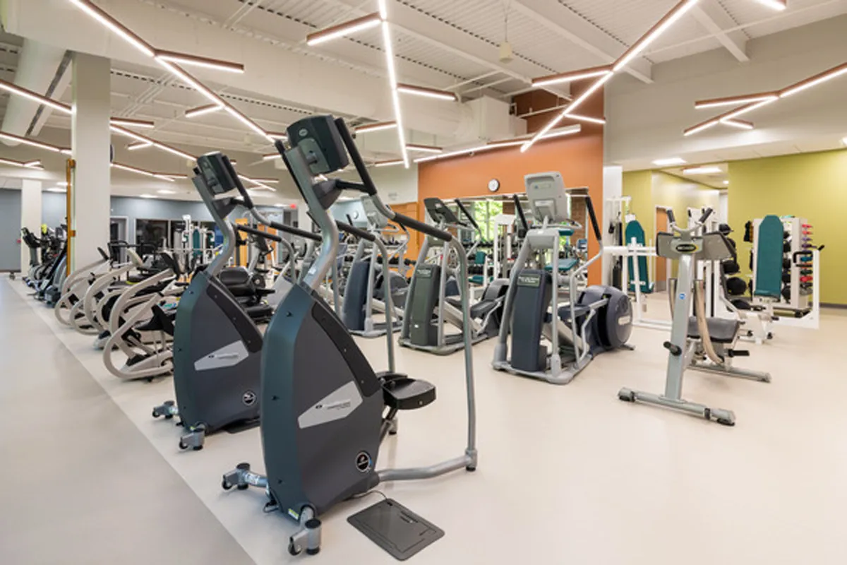 Commercial gym interior with cardio and weight equipment