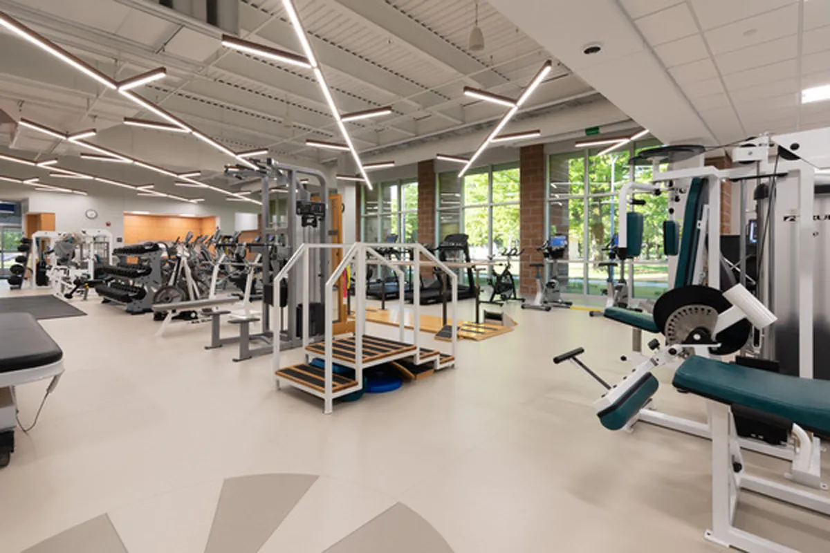 Modern fitness or physical therapy room with equipment and open layout