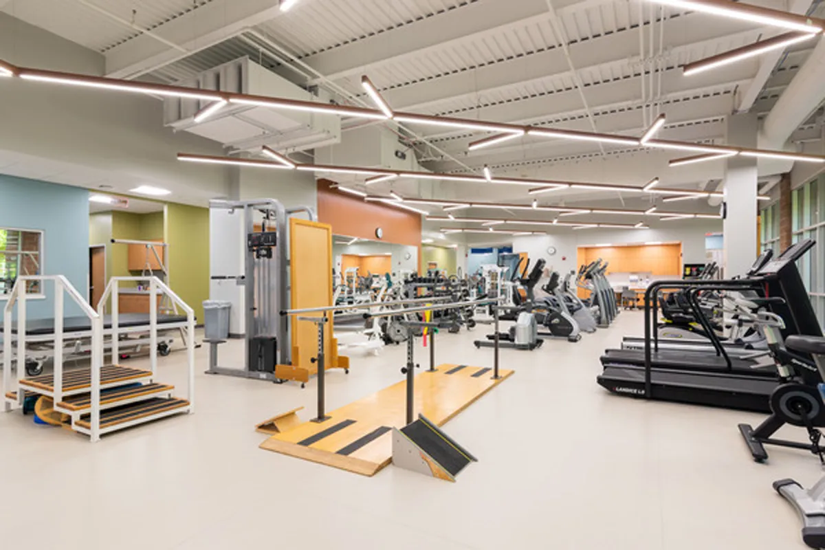 Large fitness center with rows of exercise machines and open floor plan