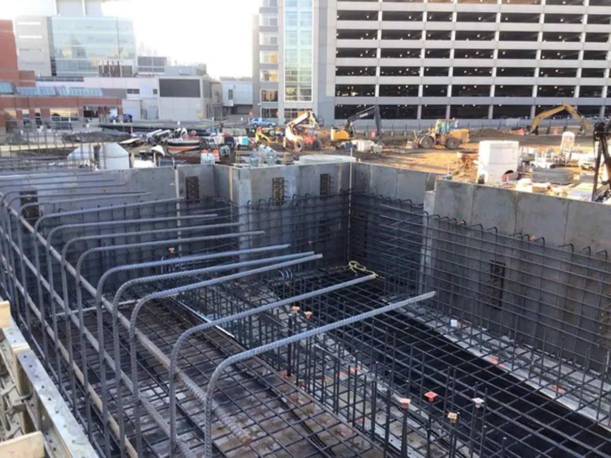 Deep concrete foundation walls under construction at a building site