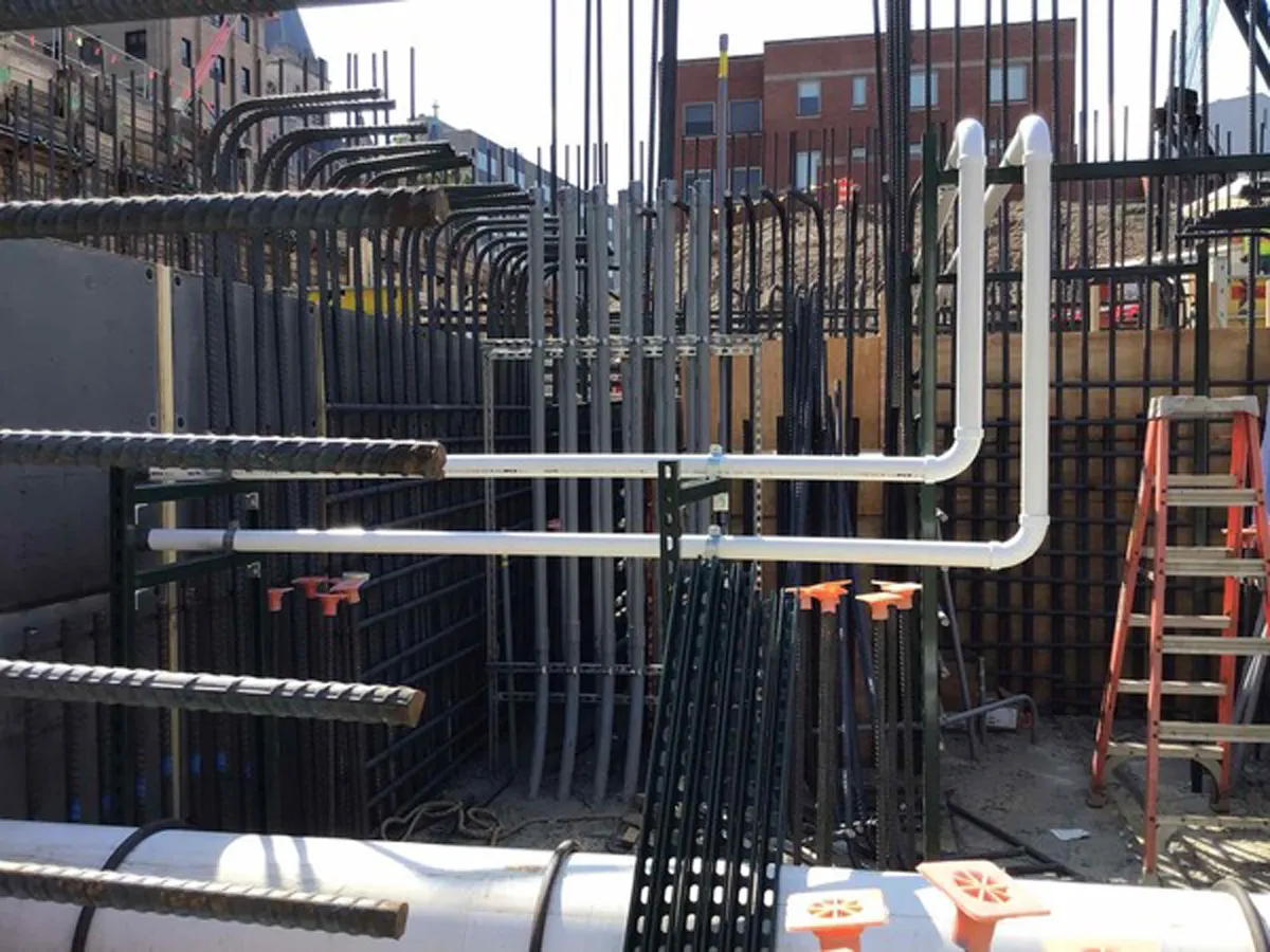 Steel reinforcement and utility conduit framing inside a building under construction