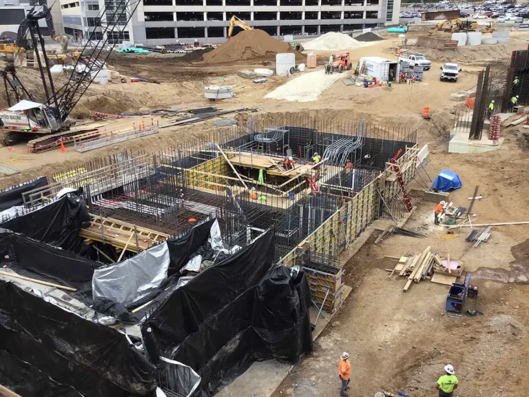 Aerial view of a large construction site with foundations and earthwork