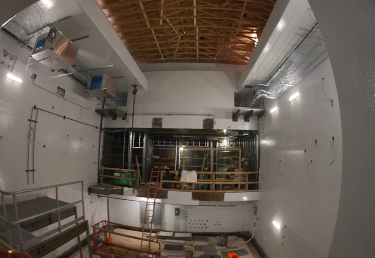Finished concrete or masonry interior wall with recessed lighting