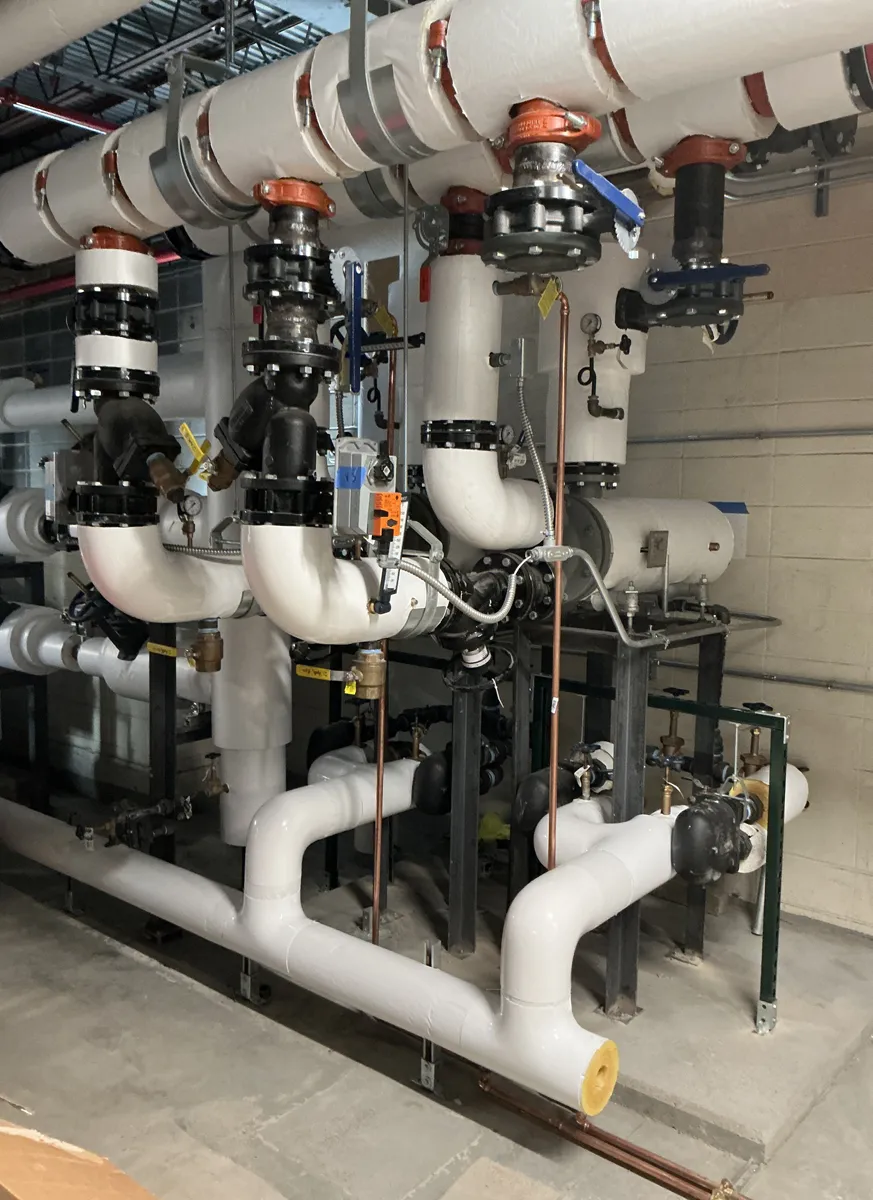 Mechanical room with complex pipe systems and industrial equipment