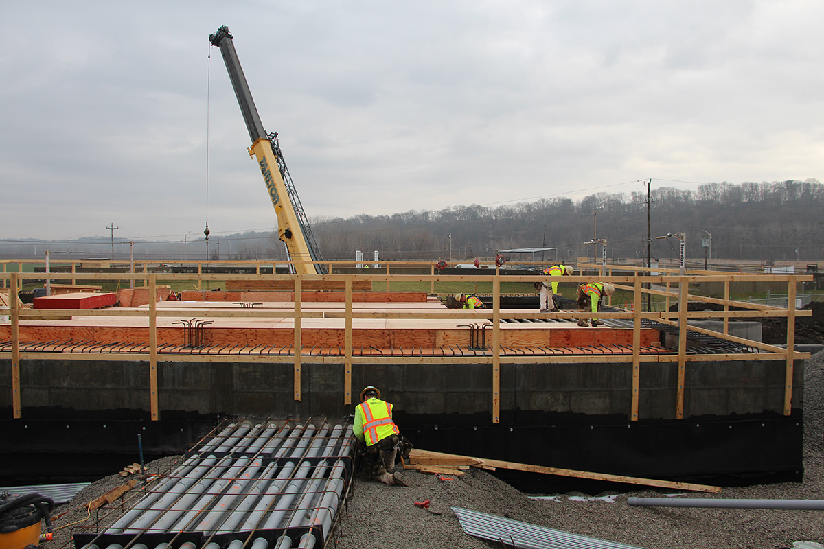 Crane and steel beams being placed at a construction site