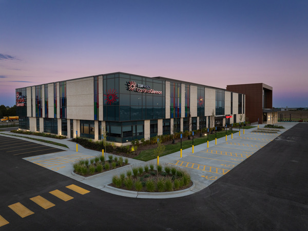 Exterior photo of a modern multi-story healthcare building at dusk