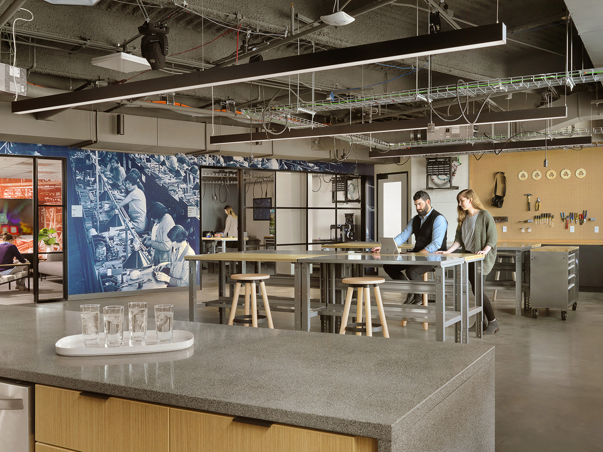 Modern lounge or break room with soft seating and a beverage station