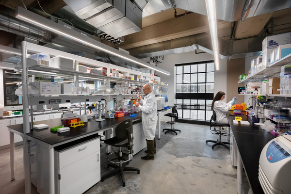 Large open industrial or laboratory space with exposed overhead systems