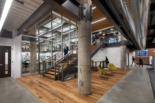 Interior staircase with wood treads and industrial-style railings in a modern building
