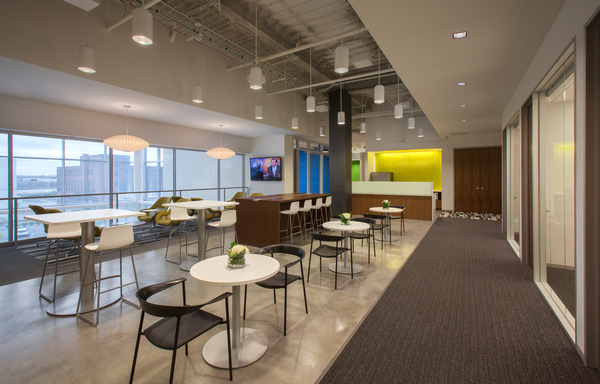Modern commercial interior with tables, chairs, and open floor plan