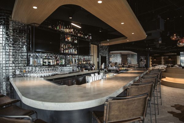Curved modern bar or lounge area with contemporary lighting and seating