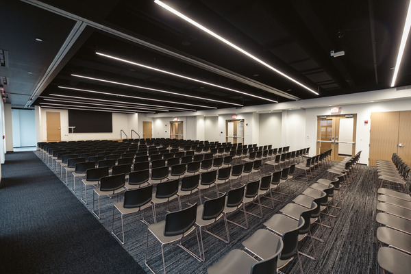 Long modern classroom or training room with rows of desks and overhead lighting