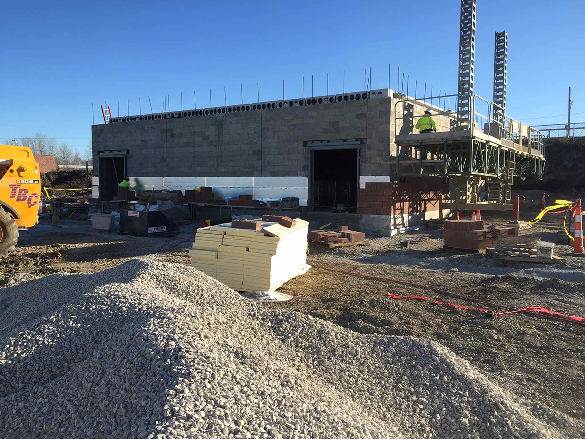 Building exterior under construction with gravel site work