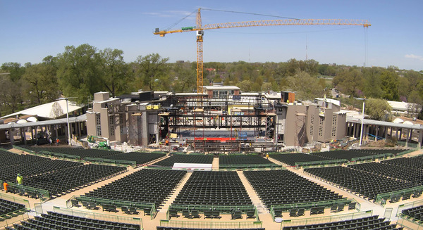 Aerial view of a large construction site with cranes and concrete foundations