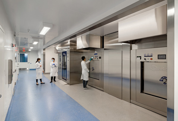 Bright lab corridor with personnel